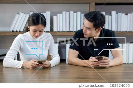 Young asian lovers using smartphone typing live chat chatting. Social network concepts, chatting conversation in chat box icons pop up. Social media marketing technology concept. Young asian lovers using smartphone typing live chat chatting. Social network concepts, chatting conversation in chat box icons pop up. Social media marketing technology concept. 102224095