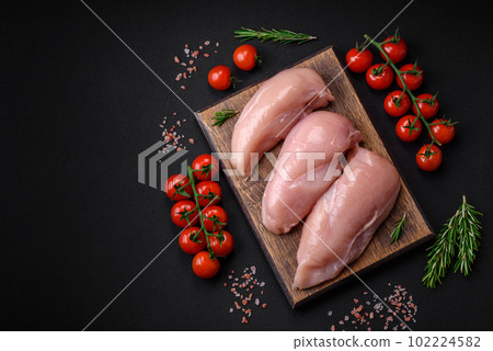 Pieces of raw chicken or turkey fillet with salt, spices and herbs Pieces of raw chicken or turkey fillet with salt, spices and herbs 102224582