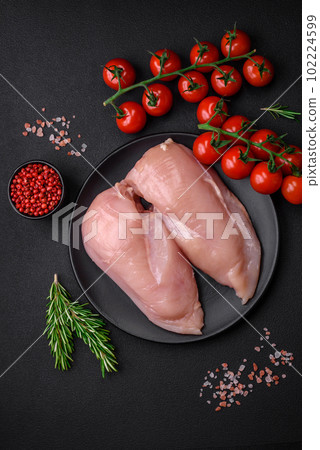 Pieces of raw chicken or turkey fillet with salt, spices and herbs Pieces of raw chicken or turkey fillet with salt, spices and herbs 102224599