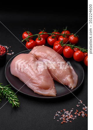 Pieces of raw chicken or turkey fillet with salt, spices and herbs Pieces of raw chicken or turkey fillet with salt, spices and herbs 102224600
