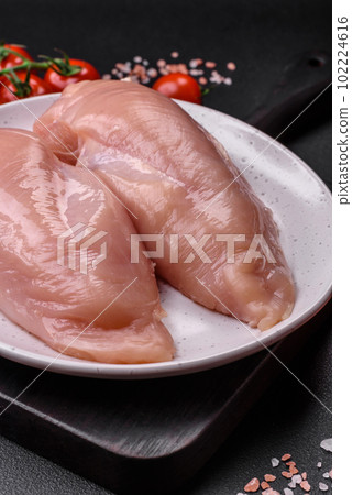 Pieces of raw chicken or turkey fillet with salt, spices and herbs Pieces of raw chicken or turkey fillet with salt, spices and herbs 102224616
