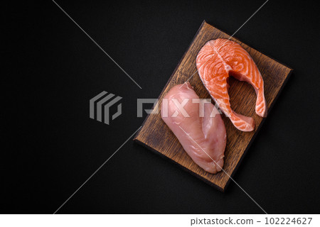 Chicken or turkey fillet and salmon steak with spices and herbs 102224627
