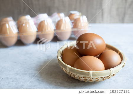 10 red eggs lined up in a plastic container and rose eggs in a colander 10 red eggs lined up in a plastic container and rose eggs in a colander 102227121