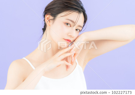 Young woman doing skin care with purple back Young woman doing skin care with purple back 102227173