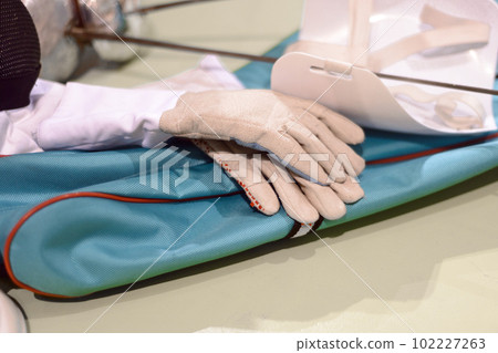 fencing equipment, white gloves lie  on the floor 102227263