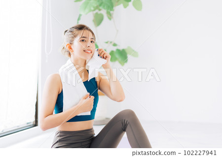 A woman sweating with a towel A woman sweating with a towel 102227941