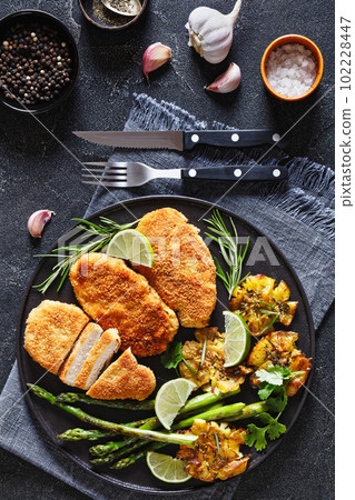 fried chicken breasts with asparagus and potatoes fried chicken breasts with asparagus and potatoes 102228447