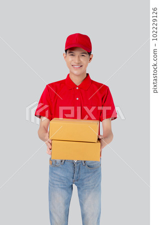 Young asian man in uniform red and cap standing carrying box stack isolated white background. Young asian man in uniform red and cap standing carrying box stack isolated white background. 102229126