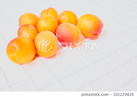 Fresh ripe apricot fruits isolated on white ribbed background 102229820