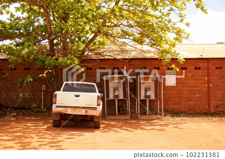 Scenery of a car without a license plate and a phone booth 102231381