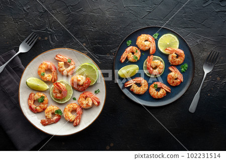 Shrimps, overhead flat lay shot. Fried shrimp with lime, two plates 102231514