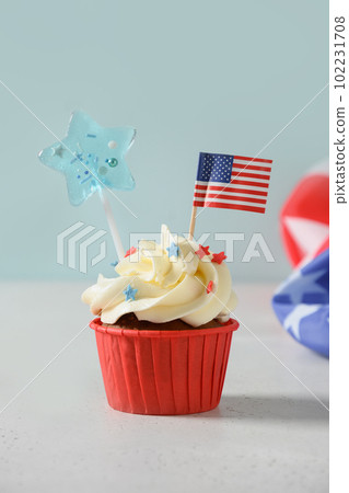 American sweet cupcakes with festive decorations and USA flag. American sweet cupcakes with festive decorations and USA flag. 102231708