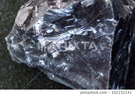 Obsidian rock. Volcanic material. Rough edges. Sharpest rock, close up macro Obsidian rock. Volcanic material. Rough edges. Sharpest rock, close up macro 102232141