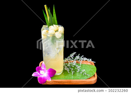 Coconut water with lotus seeds on wooden plate isolated on black background Coconut water with lotus seeds on wooden plate isolated on black background 102232260