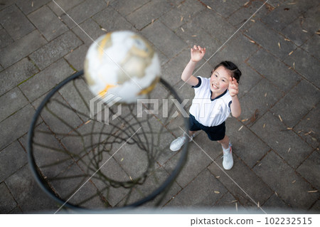 Child in gym clothes playing basketball Child in gym clothes playing basketball 102232515