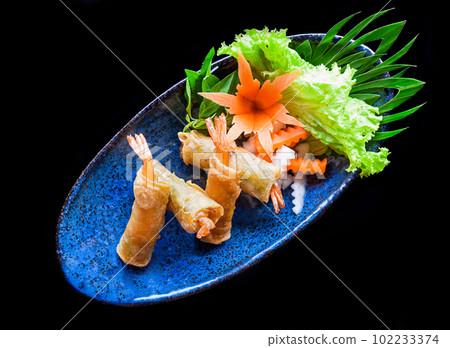 Traditional fried vietnamese spring rolls with shrimps and pork, rice paper on black background 102233374