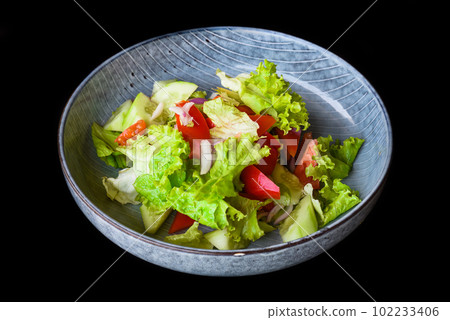 Fresh Vietnamese salad with vegetables on black background side view 102233406