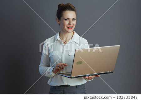 happy stylish woman worker isolated on grey 102233842