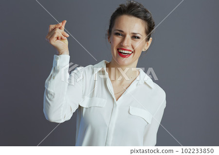 happy business owner woman fingers clicking isolated on gray 102233850