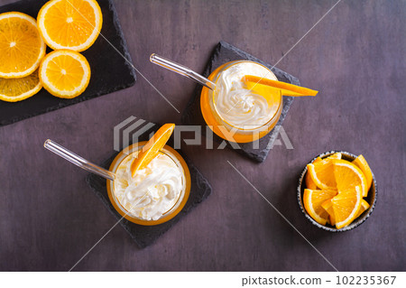 Fresh cocktail orange dirty soda in glasses on the table top view 102235367