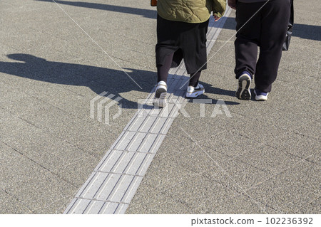 Couple walking on tactile blocks Couple walking on tactile blocks 102236392