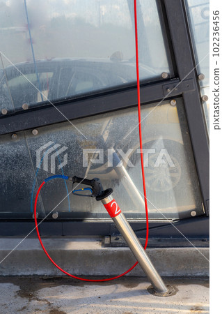 A high-pressure washing gun in a holder A high-pressure washing gun in a holder 102236456