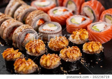 Rolls set with fish shrimp and caviar sushi with chopsticks - asian food and japanese cuisine concept 102236719