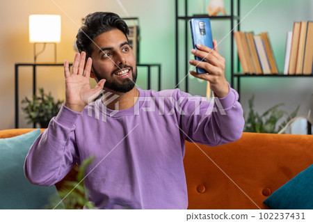Indian man blogger taking selfie on smartphone recording vlog stories for social media subscribers Indian man blogger taking selfie on smartphone recording vlog stories for social media subscribers 102237431