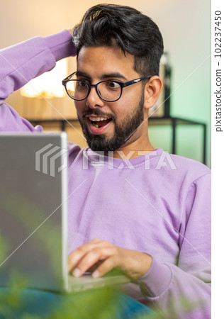 Amazed indian man use laptop computer, receive good news message, shocked by victory, celebrate win Amazed indian man use laptop computer, receive good news message, shocked by victory, celebrate win 102237450