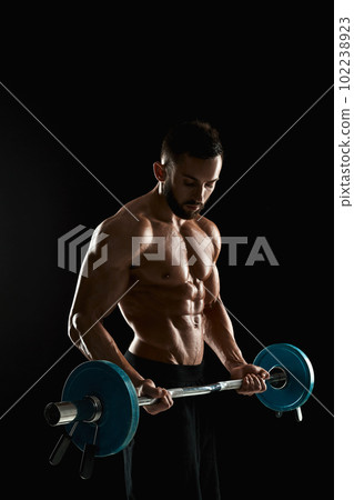 muscular man lifting weights over dark background 102238923
