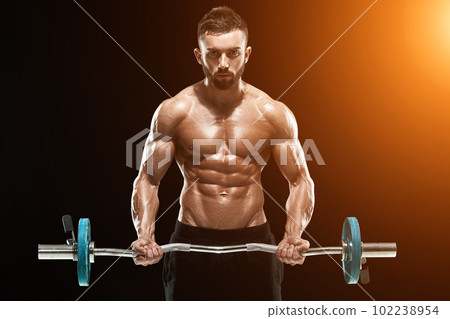 muscular man lifting weights over dark background muscular man lifting weights over dark background 102238954
