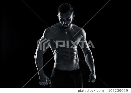 Muscular bodybuilder guy doing posing Muscular bodybuilder guy doing posing 102239029