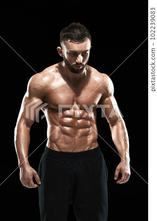 Muscular bodybuilder guy doing posing Muscular bodybuilder guy doing posing 102239083