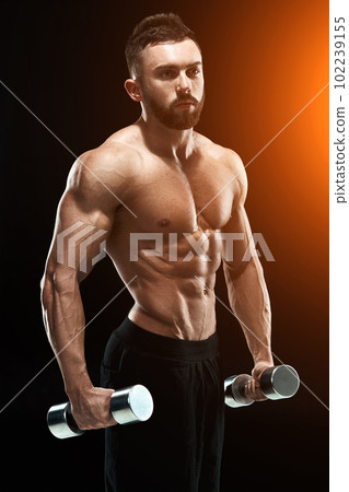 Muscular bodybuilder guy doing posing Muscular bodybuilder guy doing posing 102239155