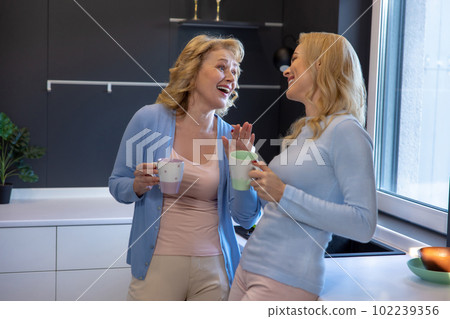 Family of two communicating in the kitchen 102239356