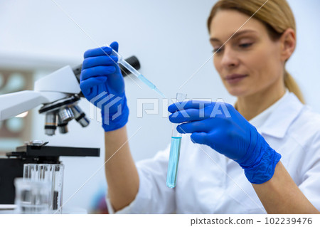 Scientist in laboratory, researcher doing investigations with test tubes, molecular biology DNA test 102239476