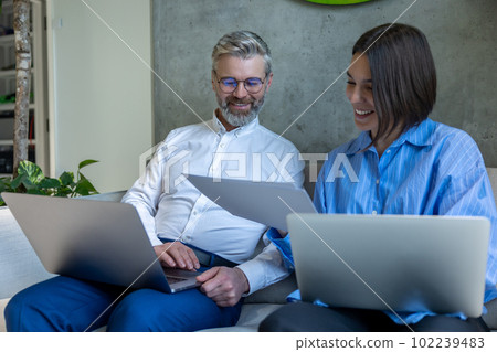 Couple scrutinizing a marriage agreement and looking involved Couple scrutinizing a marriage agreement and looking involved 102239483