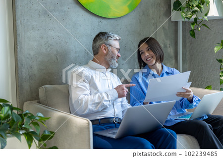 Couple scrutinizing a marriage agreement and looking involved 102239485
