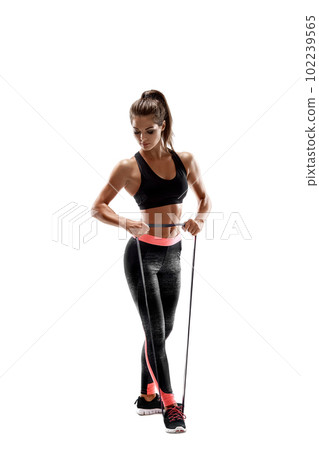 Woman exercising fitness resistance bands in studio silhouette isolated on white background 102239565