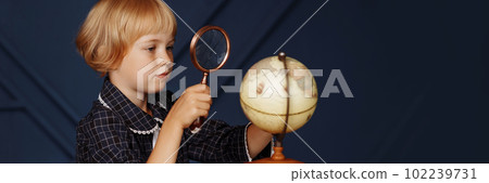 Schoolgirl studying globe 102239731