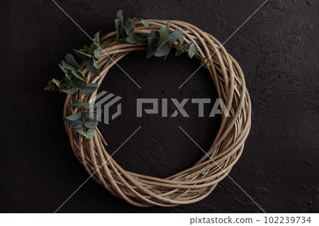 Round vine wreath on a dark background Round vine wreath on a dark background 102239734