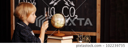 Schoolgirl studying globe Schoolgirl studying globe 102239735