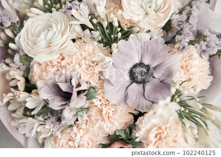 Beautiful bouquet of mixed flowers with ranunculus clooney hanoi in woman hand. Floral shop concept . Beautiful fresh cut bouquet. Flowers delivery Beautiful bouquet of mixed flowers with ranunculus clooney hanoi in woman hand. Floral shop concept . Beautiful fresh cut bouquet. Flowers delivery 102240125