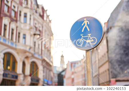 pedestrian bicycle zone sign in blue circle. city street sign concept. sign with person and bicycle in white and blue circle. pedestrian bicycle zone sign in blue circle. city street sign concept. sign with person and bicycle in white and blue circle. 102240153