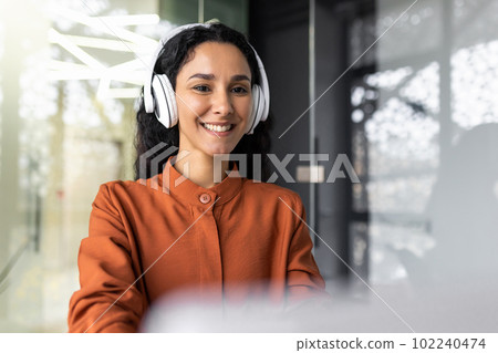 Close-up photo of young beautiful business woman with curly hair Hispanic woman. Close-up photo of young beautiful business woman with curly hair Hispanic woman. 102240474