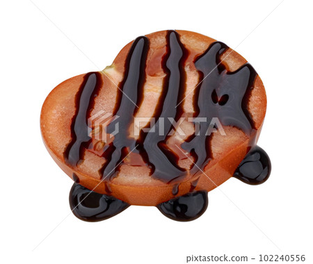 Slice of tomato with balsamic sauce isolated on white background, top view Slice of tomato with balsamic sauce isolated on white background, top view 102240556