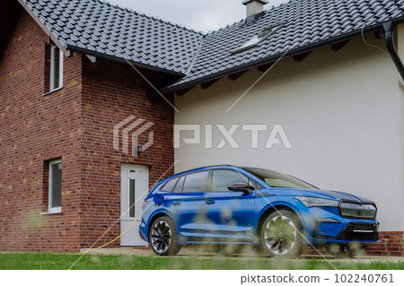 Close-up of electric car charging near family house. 102240761