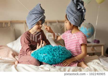 Little girl having fun during skincare routine. 102240905