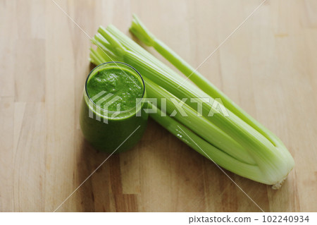 Vegan diet and nutrition, healthy detox, vegetarian concepts drinks. Glass with organic green smoothie celery on a wooden table. Healthy lifestyle concept Vegan diet and nutrition, healthy detox, vegetarian concepts drinks. Glass with organic green smoothie celery on a wooden table. Healthy lifestyle concept 102240934