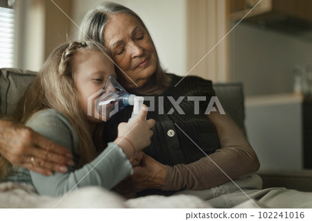 Senior woman taking care of her sick granddaughter. Senior woman taking care of her sick granddaughter. 102241016
